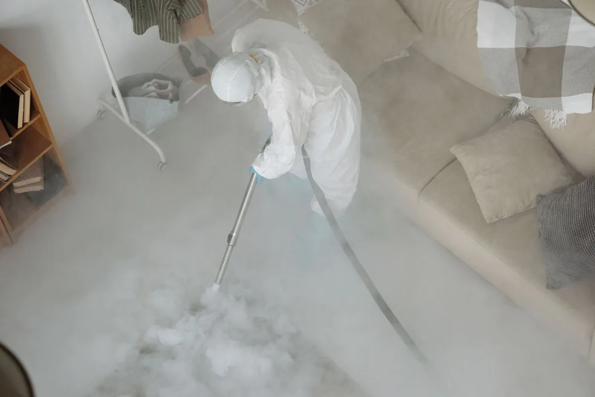 Biohazard cleanup technician in protective equipment, Oak Park Southwest, Kansas City, MO